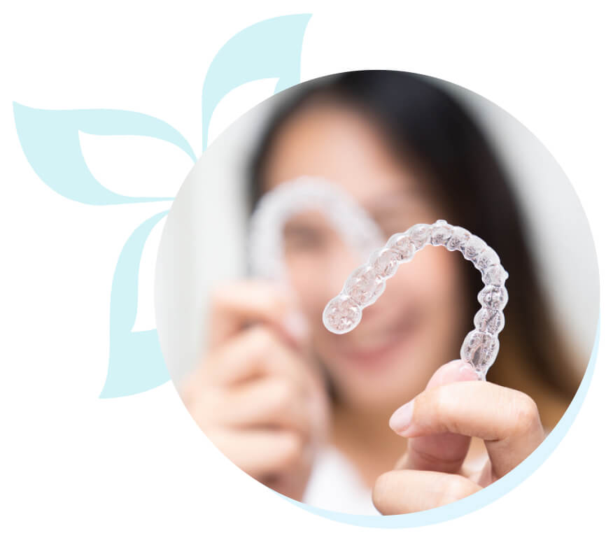 Woman holding aligner